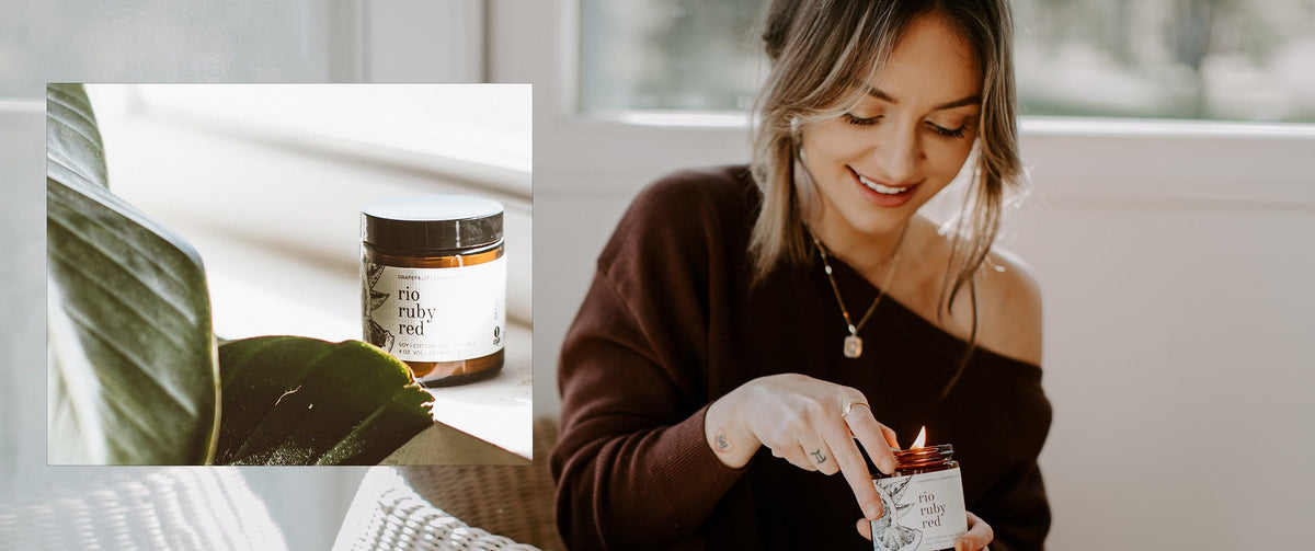 Woman in a brown sweater lights a rio ruby red candle from Broken Top Brands Candles & Incense, with a plant in the foreground