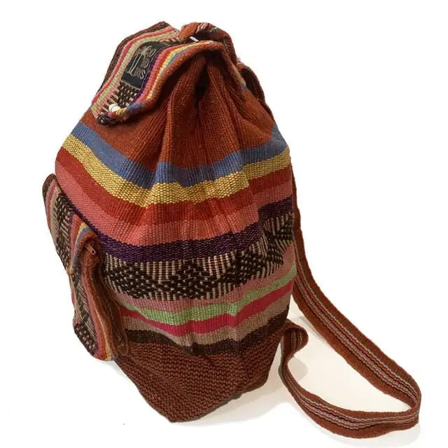 Side view of Baja Backpack in Red Clay showing colorful woven stripes and side pocket
