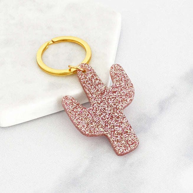 Acrylic cactus shaped keyring with pink glitter and a gold ring