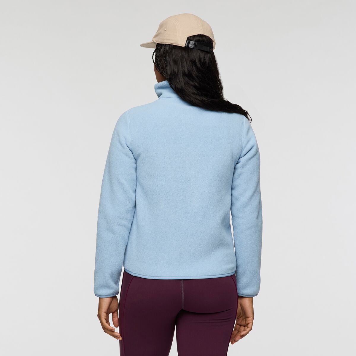 Back view of light blue Cotopaxi Teca Fleece Full Zip Jacket worn by a model with a beige cap