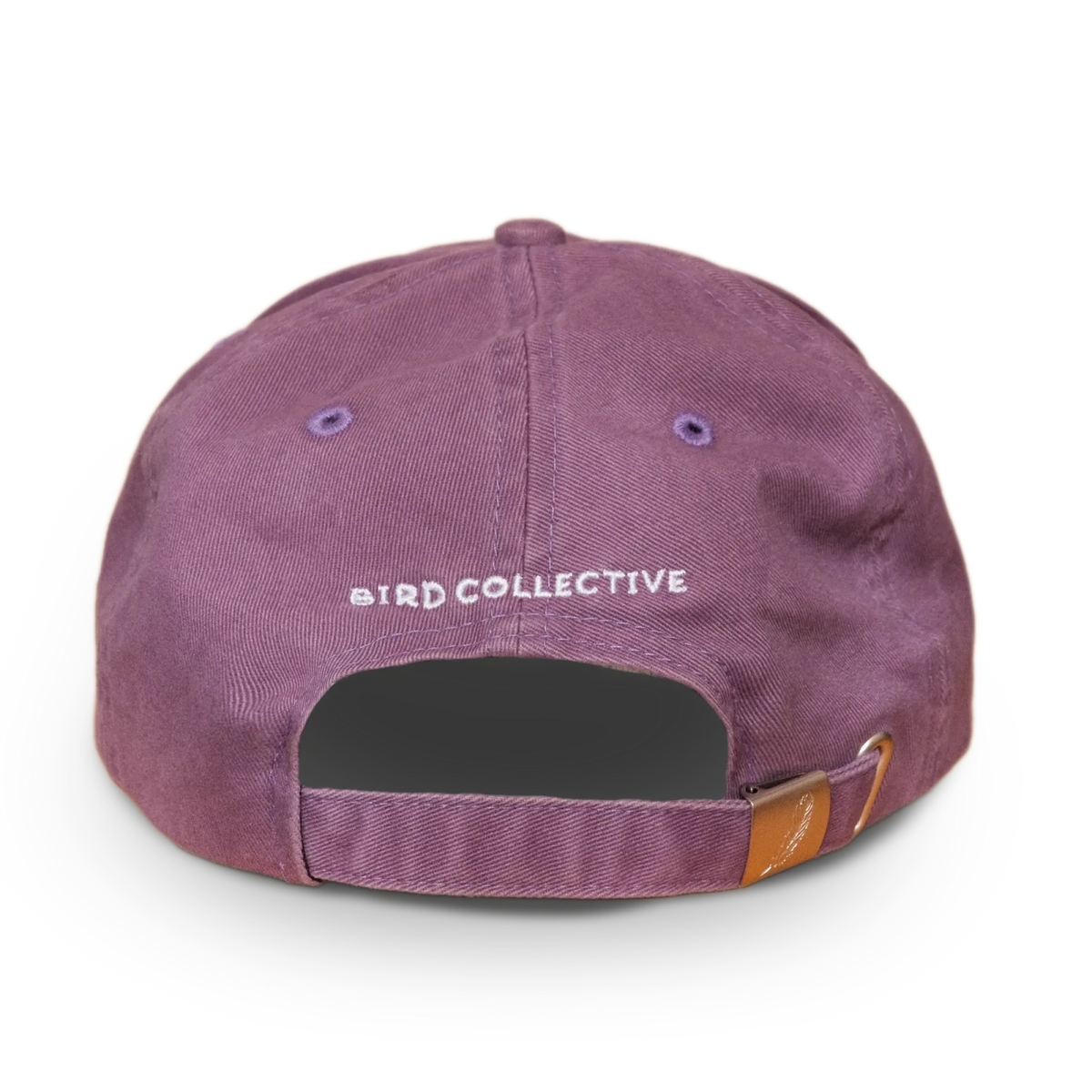 Rear view of a purple washed dad hat with Bird Collective embroidery