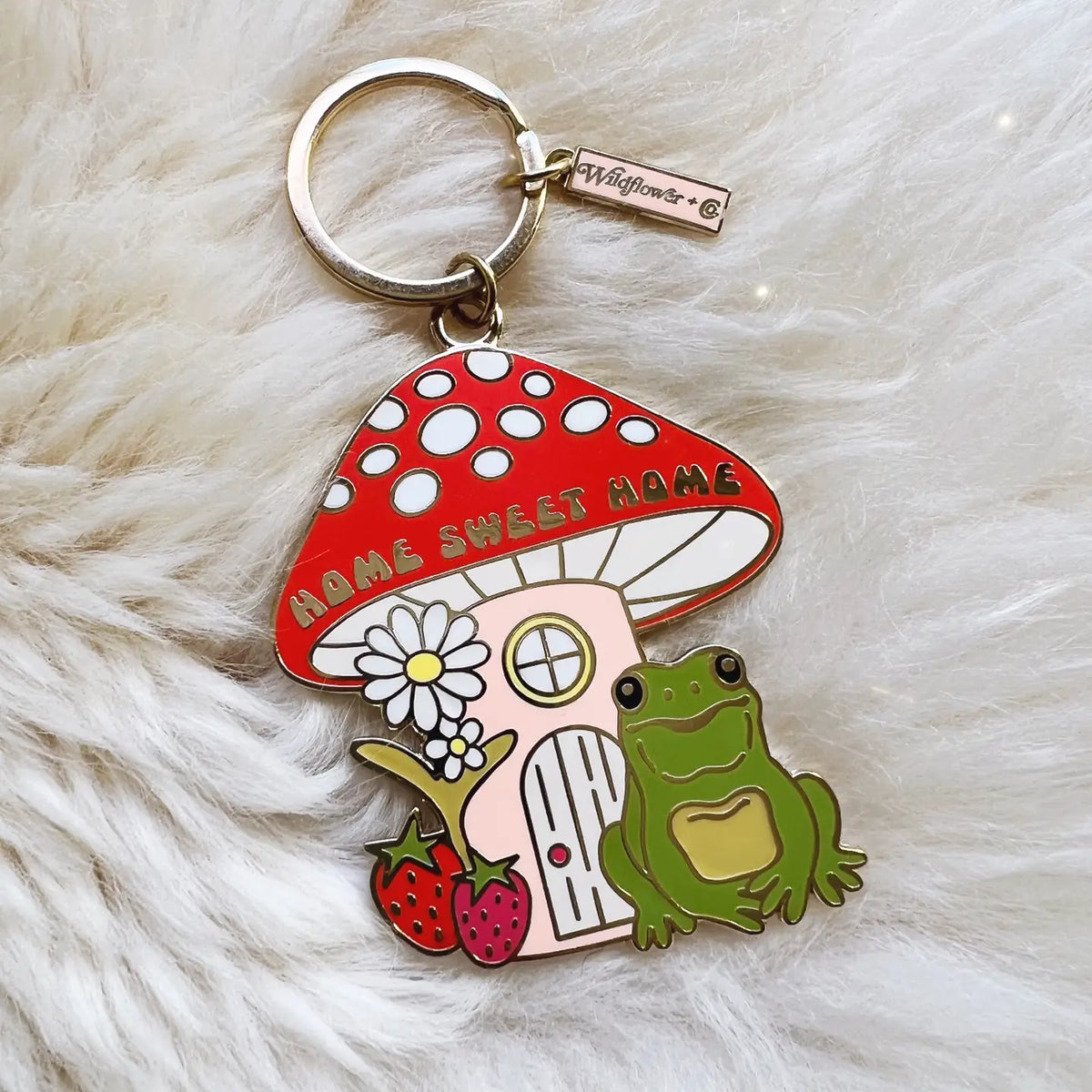 Home Sweet Home Frog Keychain featuring a red mushroom house and a green frog.