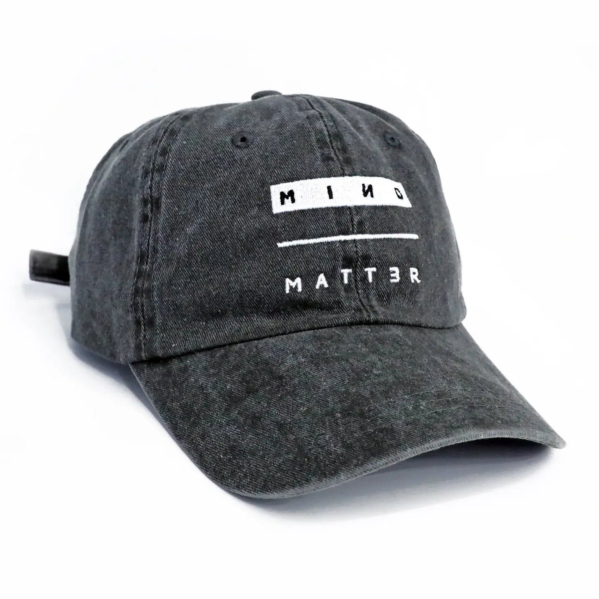Mind Over Matter denim dad hat front view with a white logo banner on the front panel