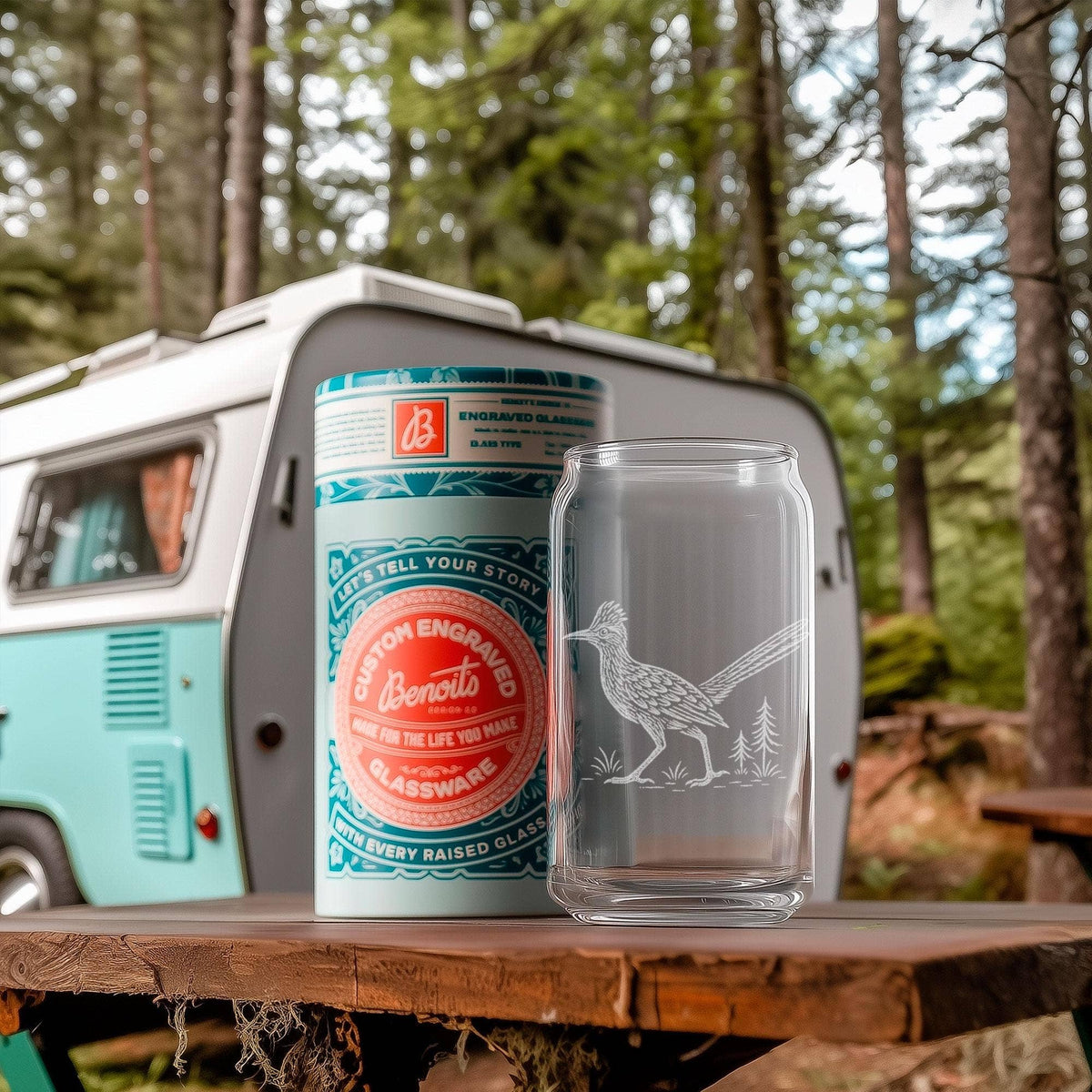 Road Runner whiskey glass with teal label art resting on a vintage camper in a forest setting.