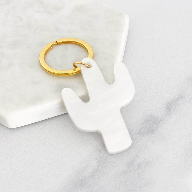 White cactus shaped acrylic keyring with a gold ring