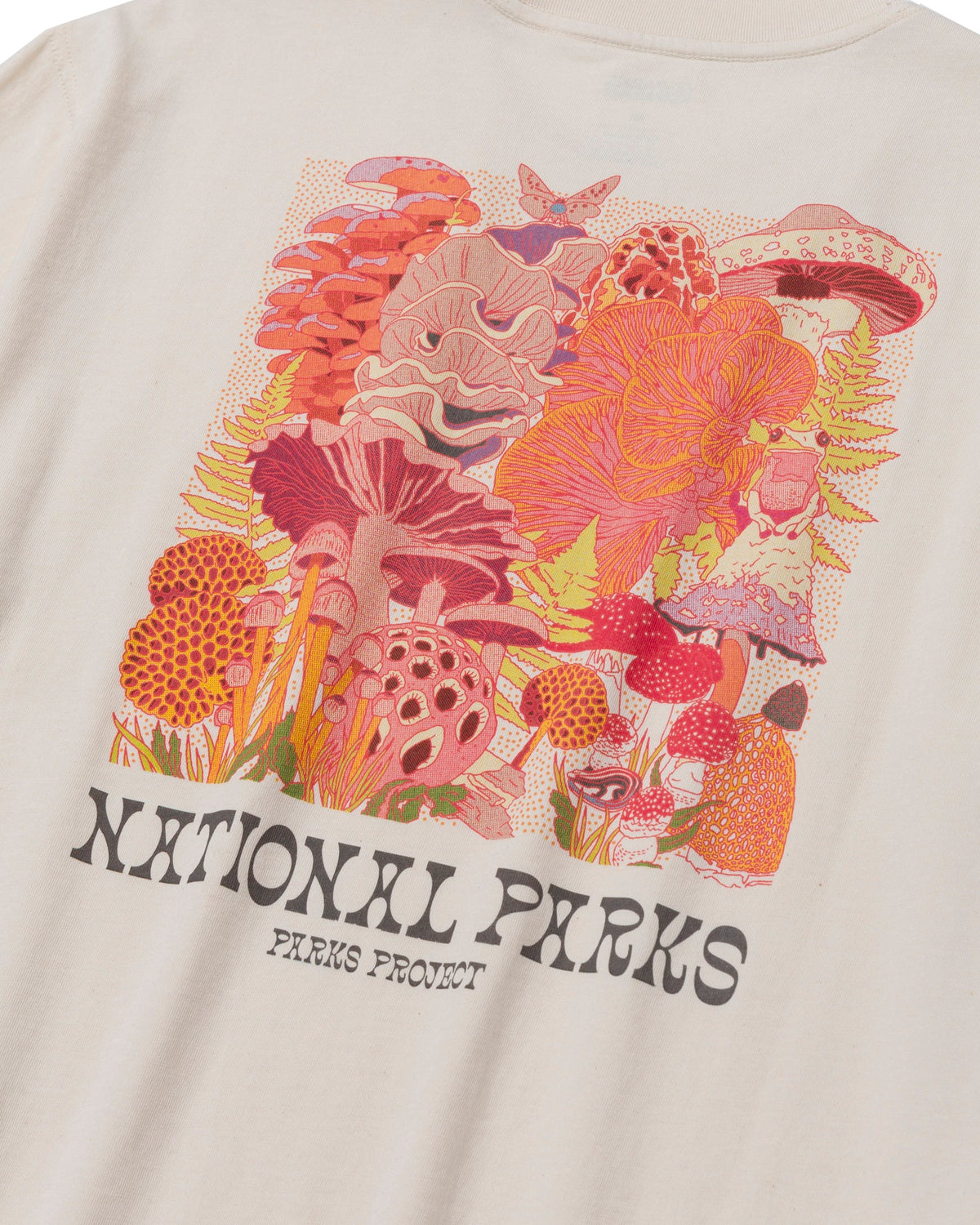 Front view of a cream pocket tee with a large colorful floral print across the pocket area.