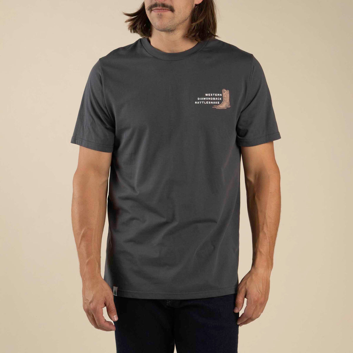 Front view of man wearing dark gray T shirt with Western Diamondback rattlesnake graphic on the chest
