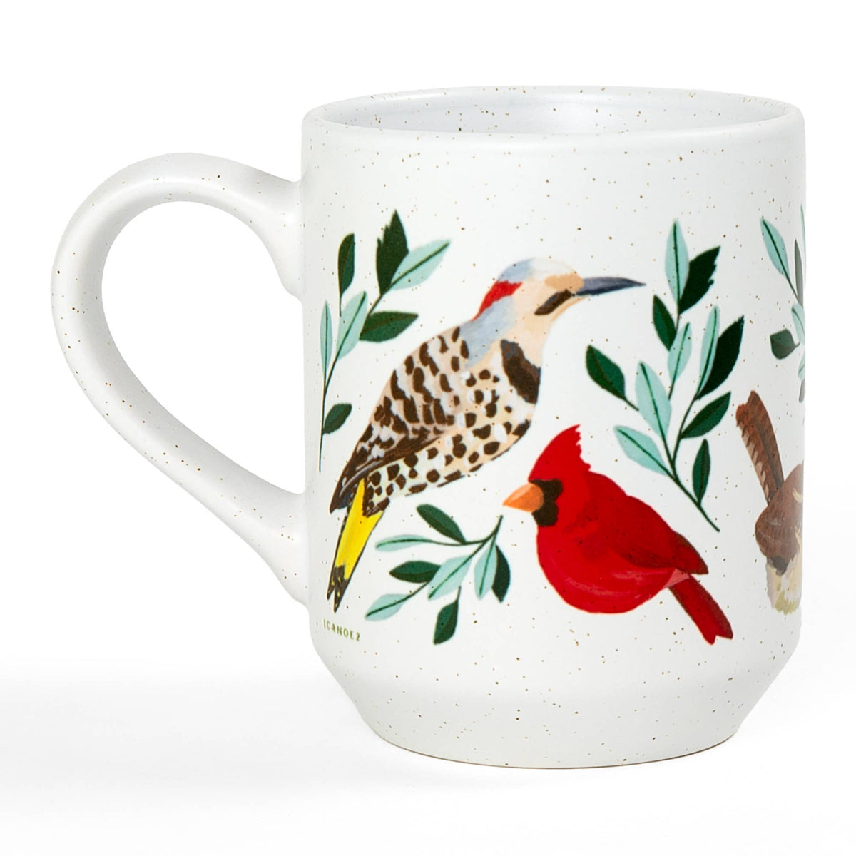 Side view of a white speckled ceramic mug with botanical pattern and a partial handle.