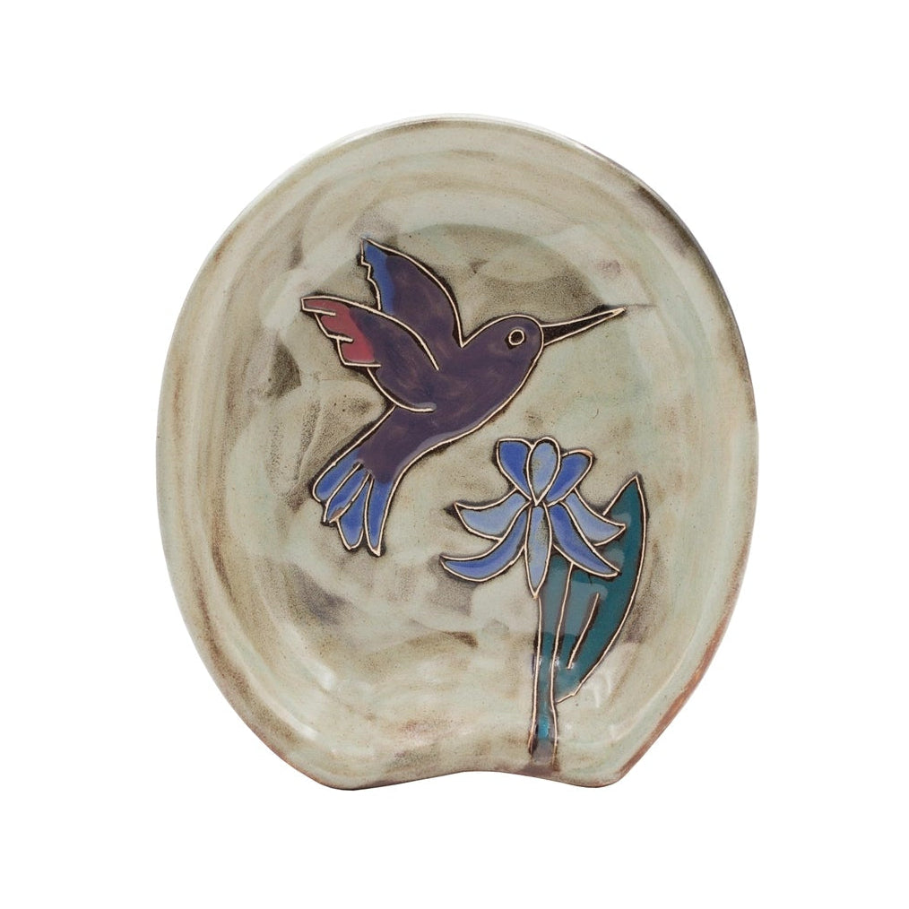 Spoon rest showcasing a purple hummingbird and blue flower on a beige glazed ceramic surface