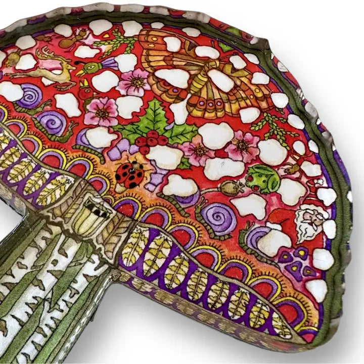 Close up of mosaic mushroom shaped magnet showing layered patterns and bright colors