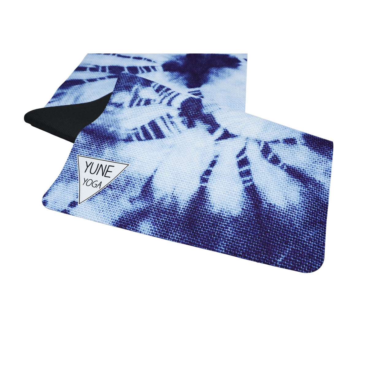 Blue and white tie-dye foldable suede yoga travel mat partially unrolled with YUNE YOGA logo