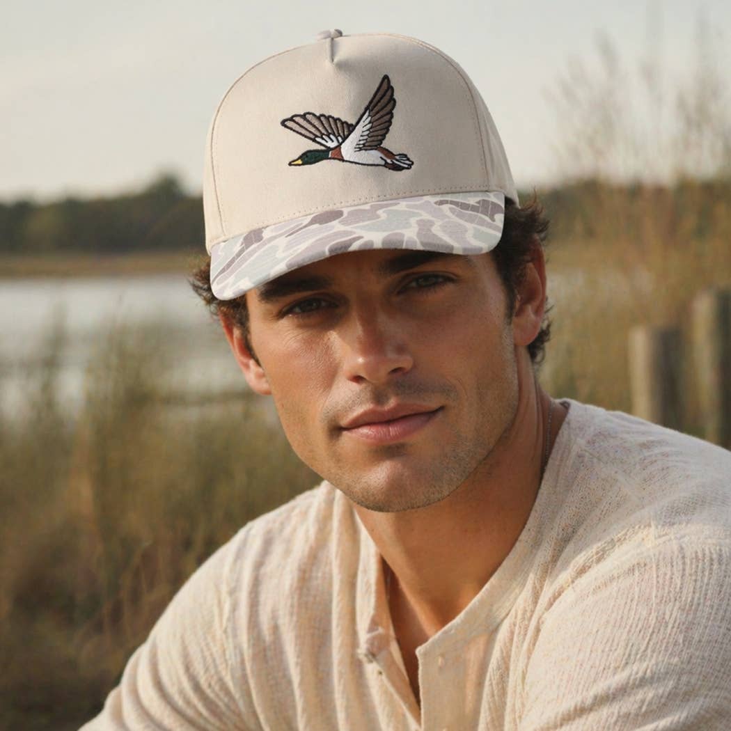 Beige Flying Mallard embroidered camo brim trucker hats on display