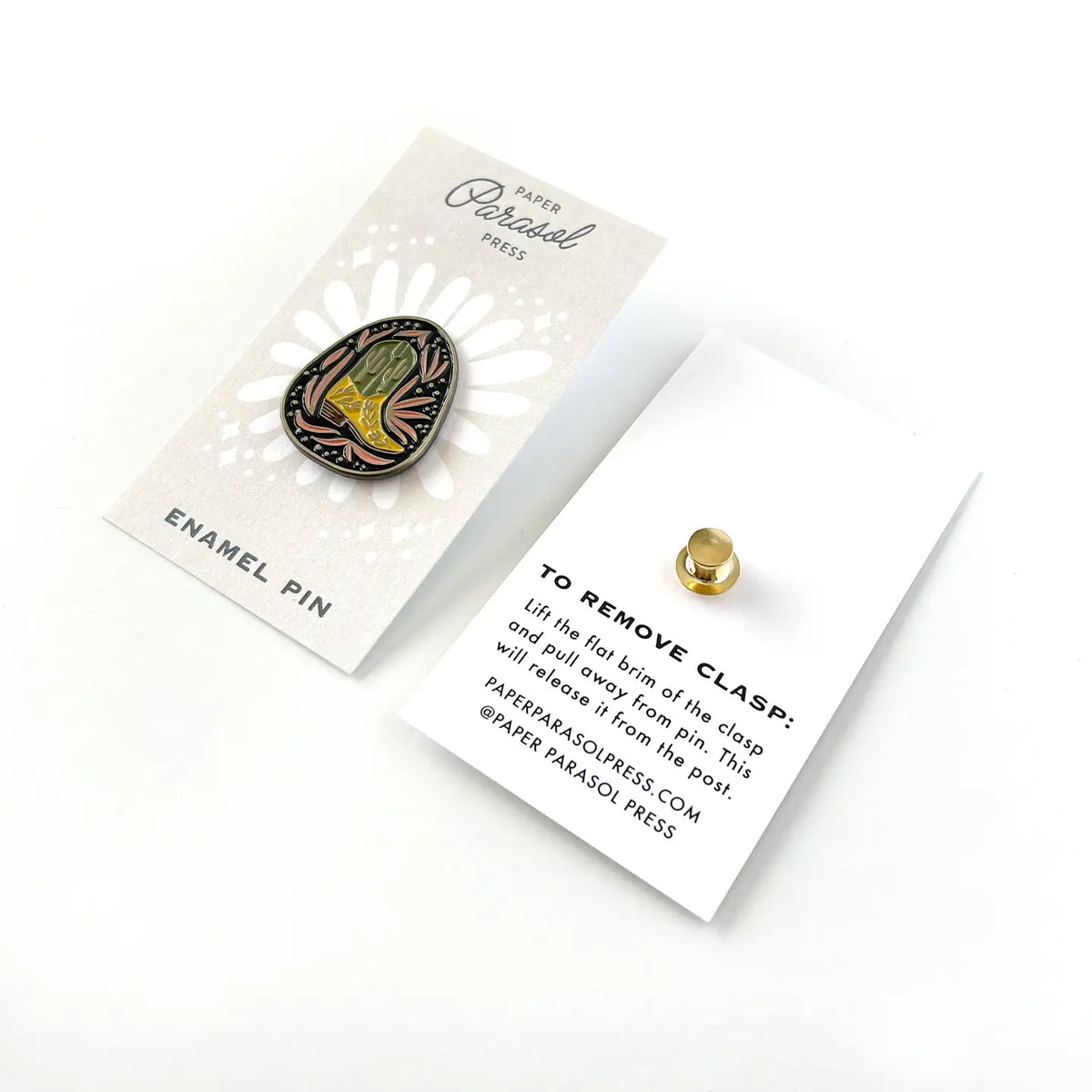 Baja Boot enamel pin displayed on a white Parasol Press card with a gold clutch back nearby.