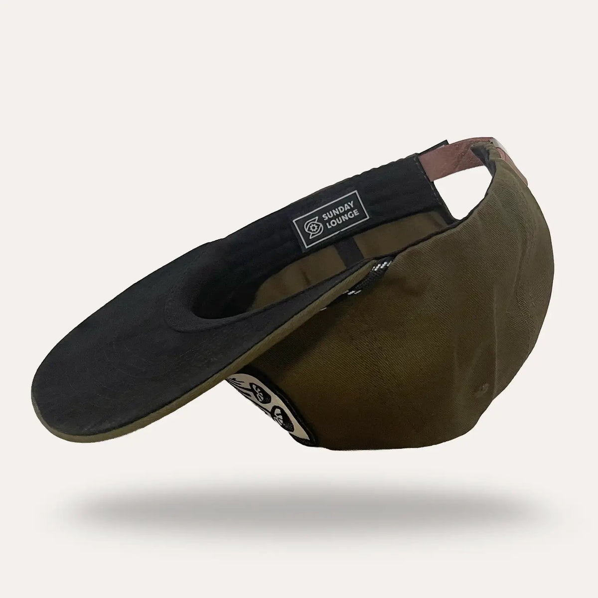 Groovy Mushrooms Forest Twill Flatbrim Hat with black brim, olive crown, back strap, and Sunday Lounge patch.