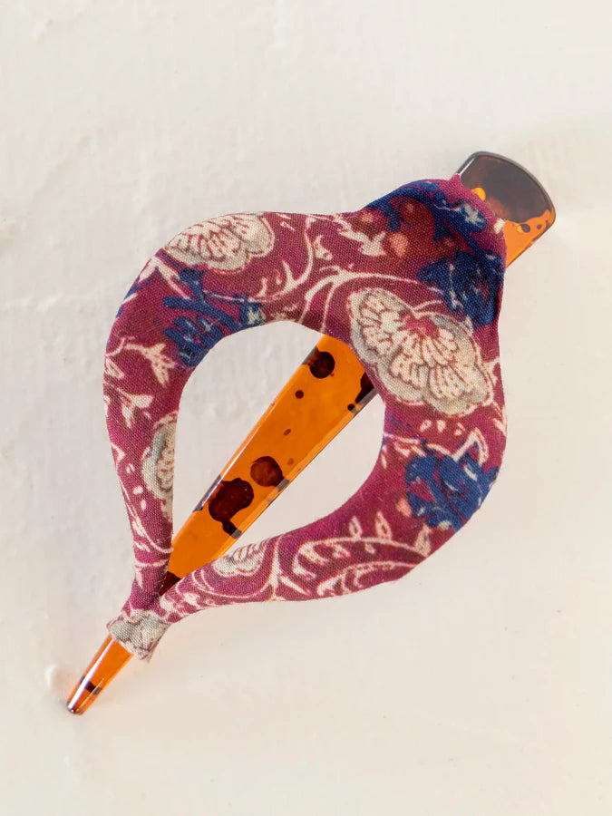 Boho fabric hair clip wrapped in pink floral pattern on an orange base