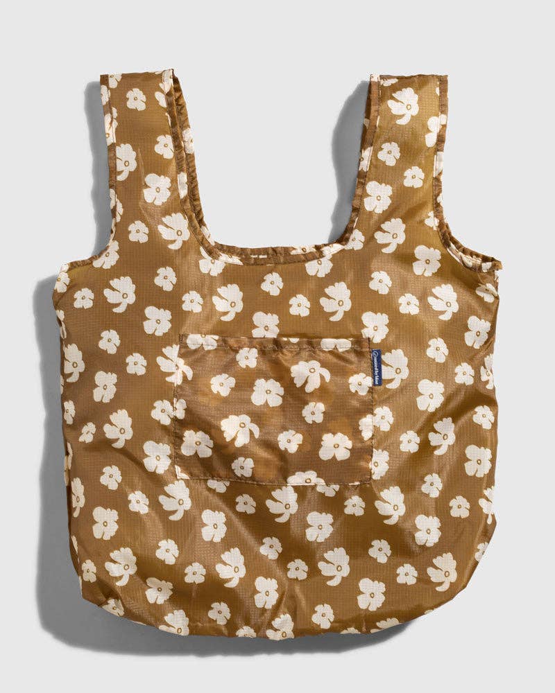 The Packable Tote in brown with white floral print and shoulder straps