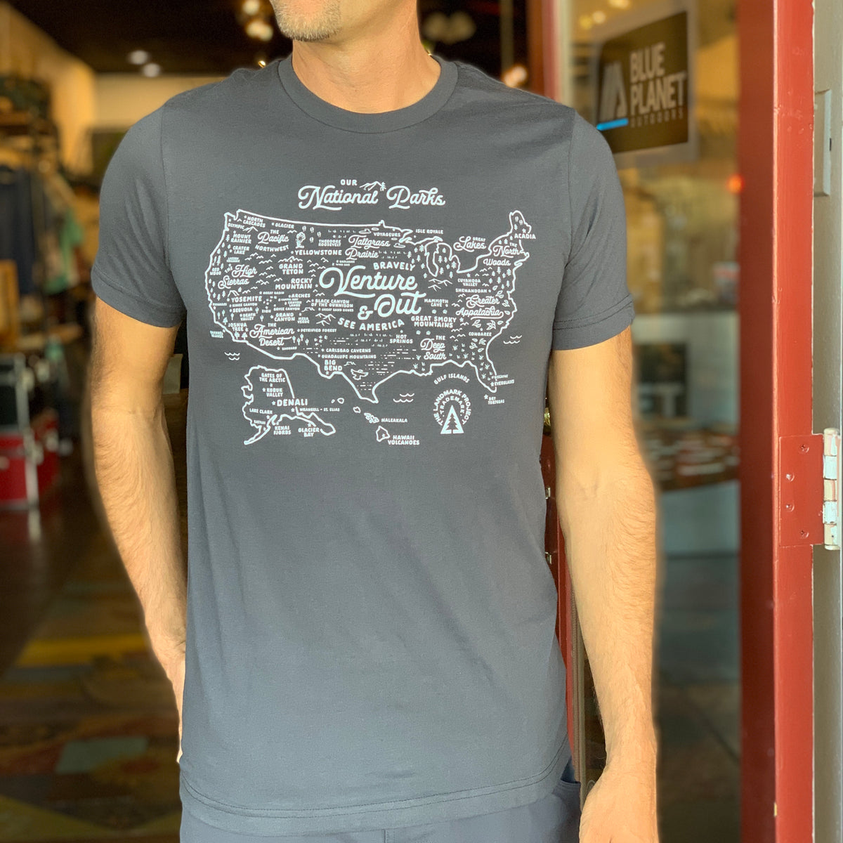 Man wearing deep navy National Parks Map Tee with white map print