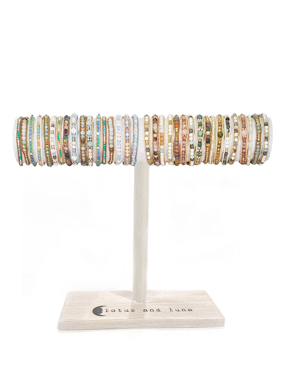 Moonbeam bracelets displayed as a row of pastel beaded wraps on a white stand
