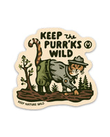 Sticker featuring a cat in outdoor gear prowling through a forest scene with Keep the Purrks Wild.