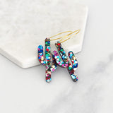 Elongated acrylic cactus shapes covered in rainbow rhinestones on gold hoops.