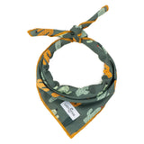 Close up of a Looking Sharp Bandana tied in a knot, green fabric with orange edging.