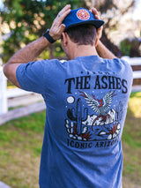 Back view of a man wearing a blue From the Ashes T shirt with a bold phoenix desert graphic and Iconic Arizona text