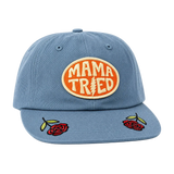 Blue denim Mama Tried hat with an orange circular patch on the front and a top button.