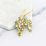Gold glitter elongated cactus hoop earrings encrusted with crystals and gold ear wires.