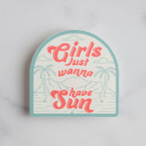 Rounded sticker with turquoise border featuring coral text Girls Just Wanna Have Sun over a tropical beach scene with palm trees.