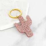 Acrylic cactus shaped keyring with pink glitter and a gold ring