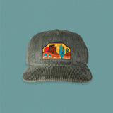 Gray corduroy five panel hat with a desert themed patch visible at the front.