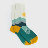 Peak Experience Socks with teal mountain graphics, sun motif, and mustard yellow toe caps.