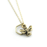 Gold honeybee charm necklace with hexagon frame on a delicate chain