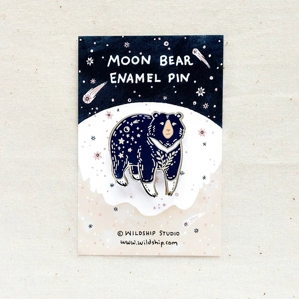 Moon Bear enamel pin displayed on a starry night packaging card with space motifs.