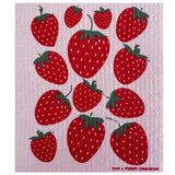 Strawberry Fields Swedish dishcloth with red strawberries on a pink textured background.