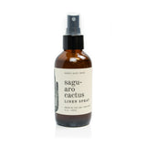 Amber glass spray bottle labeled Saguaro Cactus Linen Spray with black cap
