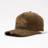 Brown corduroy Fisher hat with an embroidered patch showing a fish and wilderness scene.