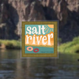 Salt River sticker centered in a gold frame against a blurred riverside backdrop