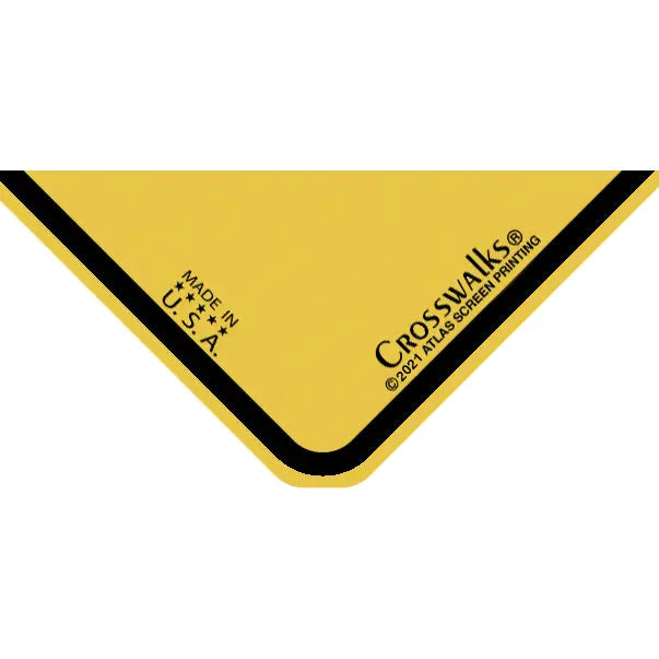 Close up of a yellow sign corner with a black border and Crosswalks branding.
