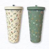 Cream and green floral travel tumblers with matching lids and small heart knobs.