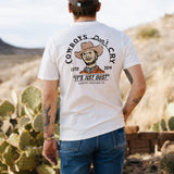 Back view of a man wearing a white Cowboys Don't Cry tee in a desert landscape with a large back graphic.