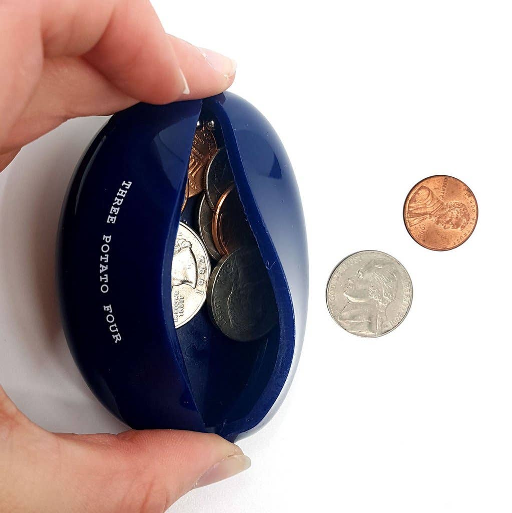 Blue oval coin purse being opened by fingers, coins inside and nearby on a white background.