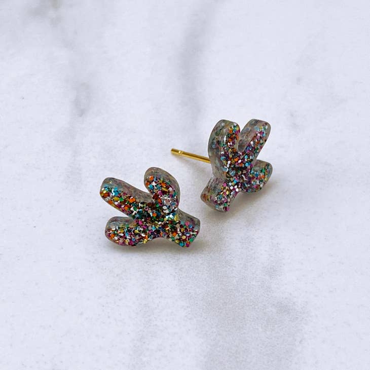 Glittery acrylic cactus stud earrings in translucent gray with multicolored speckles and gold posts
