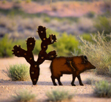 Rustic metal cutout of a javelina beside a prickly pear cactus in a desert scene