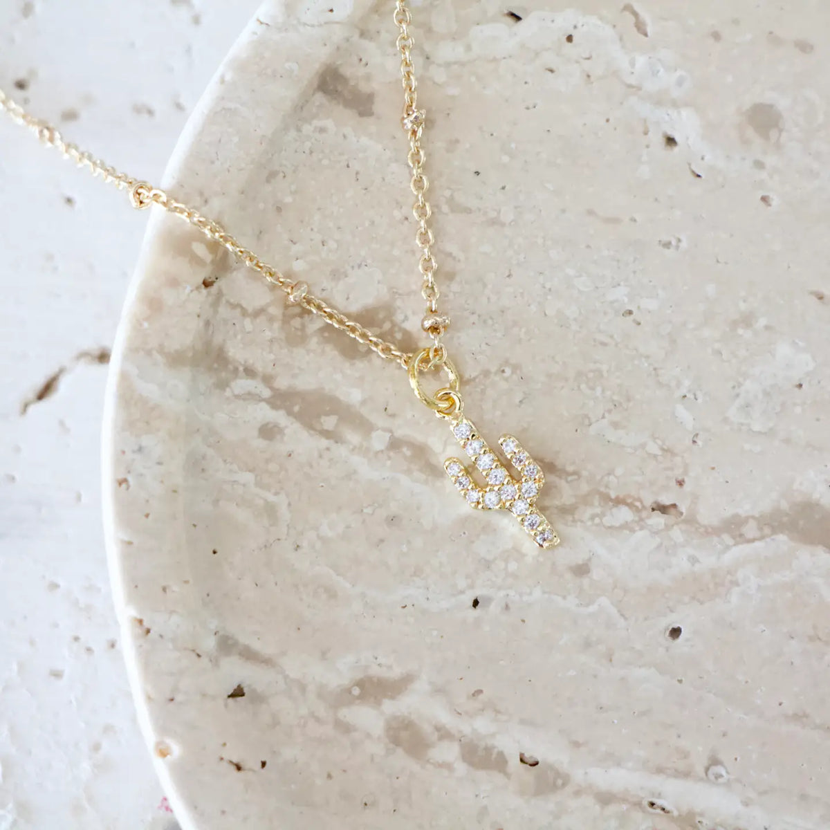 Gold chain necklace with a diamond encrusted cactus pendant
