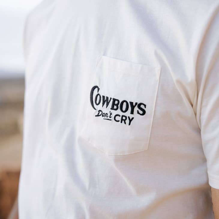 White Cowboys Don't Cry tee with a chest pocket embroidered with a black logo.