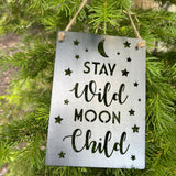 Stay Wild Moon Child metal sign with moon and star cutouts hanging from twine.
