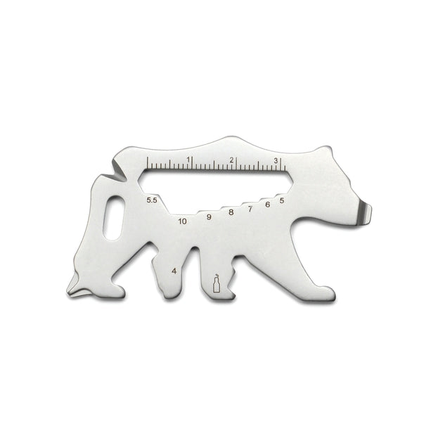 Bear shaped stainless steel multitool with ruler markings along the top edge and tool cutouts
