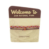 Zion National Park bracelet with braided purple and red cords and a bead on a canyon themed card.