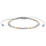 Beaded bracelet with pastel pink lavender and blue beads with gold spacers on a gray adjustable cord